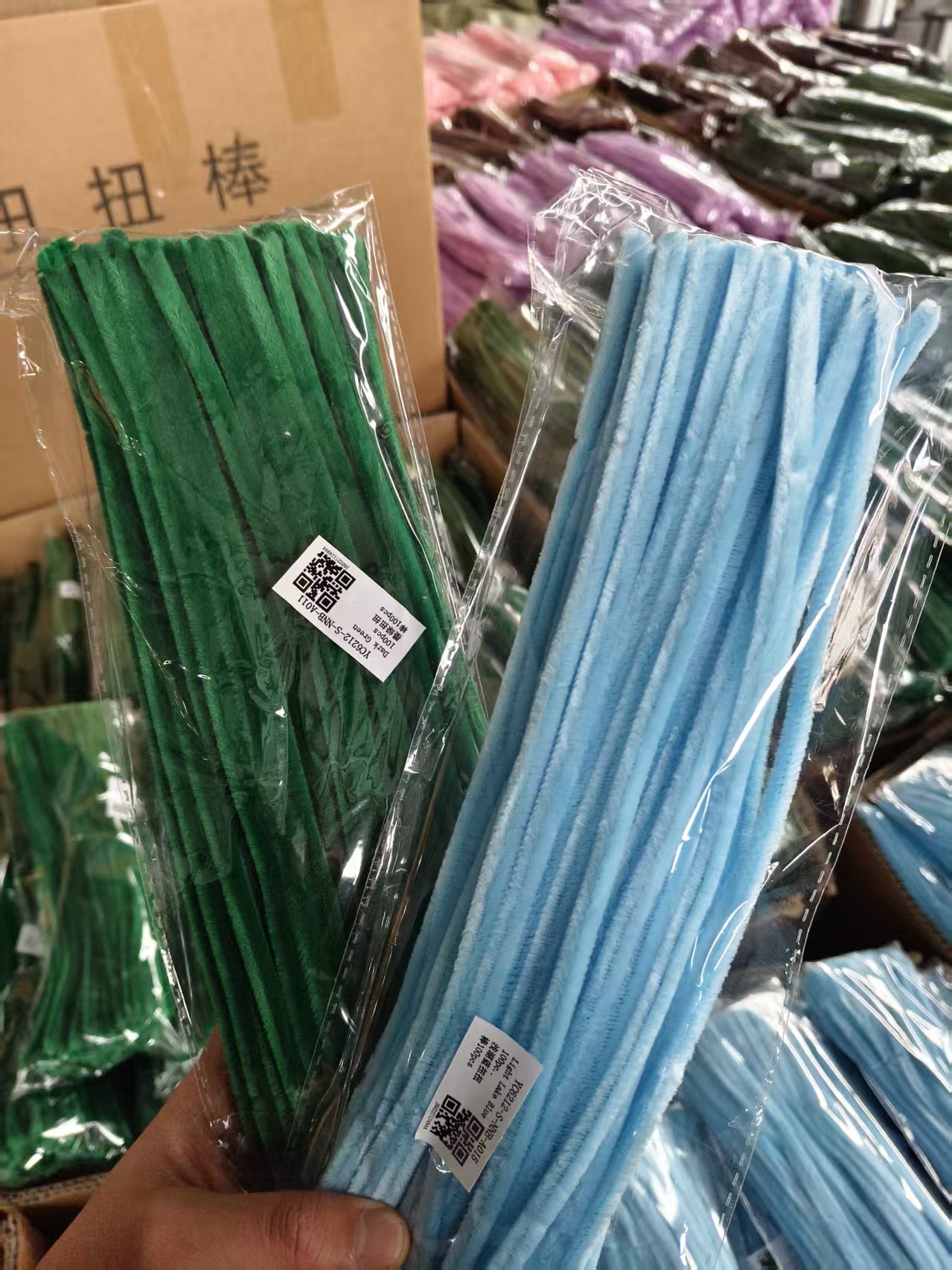 Packaged standard chenille stems in green and sky blue colors